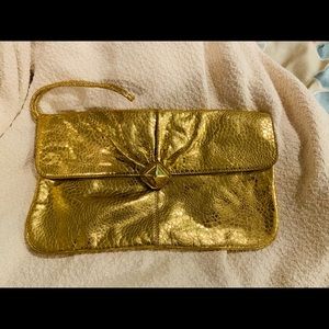 Gold clutch with wrist attachment